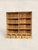 A charming antique English pine open bookcase, circa 1900, with a warm honey-toned finish, practical open shelving, and...
