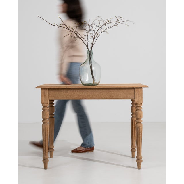 A 19th century French side table crafted in oak and designed in the Louis XVI style, featuring a rectangular top and...
