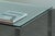 A refined 1990s Danish Modern coffee table in clear glass and polished chrome. The clean rectangular silhouette pairs a...