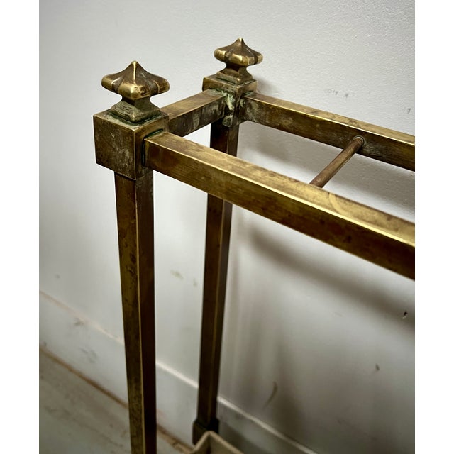 Brass umbrella stand Made of square brass tubing The water collection tray is made of painted sheet iron Good condition...