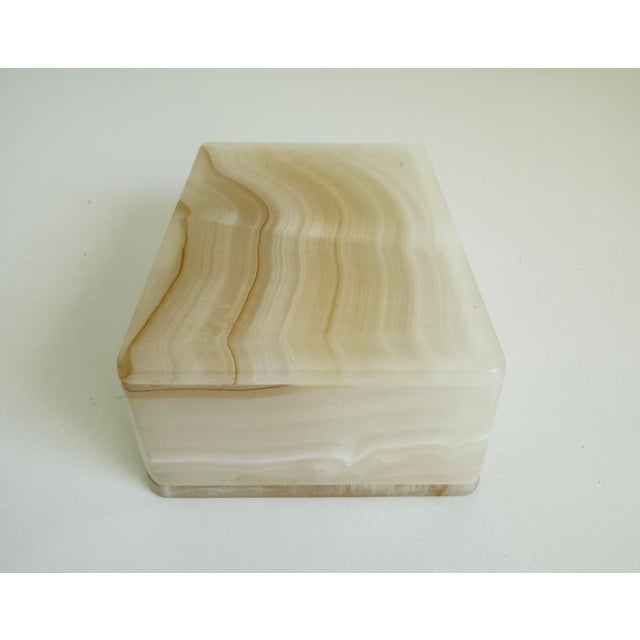 A vintage rectangular lidded box crafted in Italy from natural zebra onyx stone. It features distinct, translucent mineral...