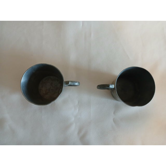 Antique pewter tankard pair. Great addition to a pewter collection or to start off your collection. Marking has worn off...