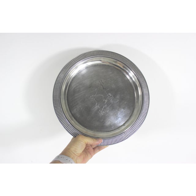 11” antique round silver quadruple plated gallery tray with a wide ribbed lip, and embossed detail on the base. In very...
