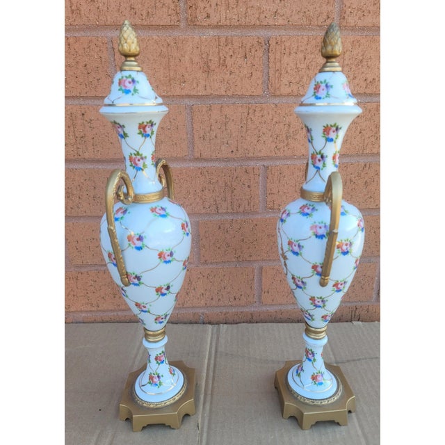 Pair of French Hand-Painted Porcelain and Gilt Metal Amphoras with no chips or cracks. Measure 5" in width, 4" inches in...