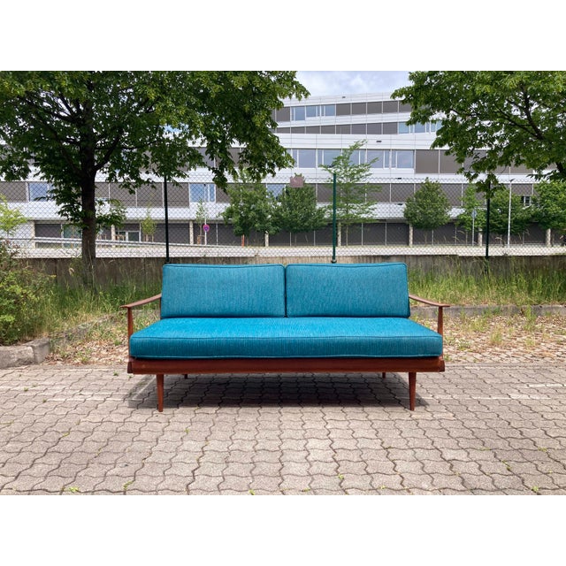This Wilhelm Knoll Antimott Sofa features its original blue petrol wool upholstery fabric with innerspring seating and an...