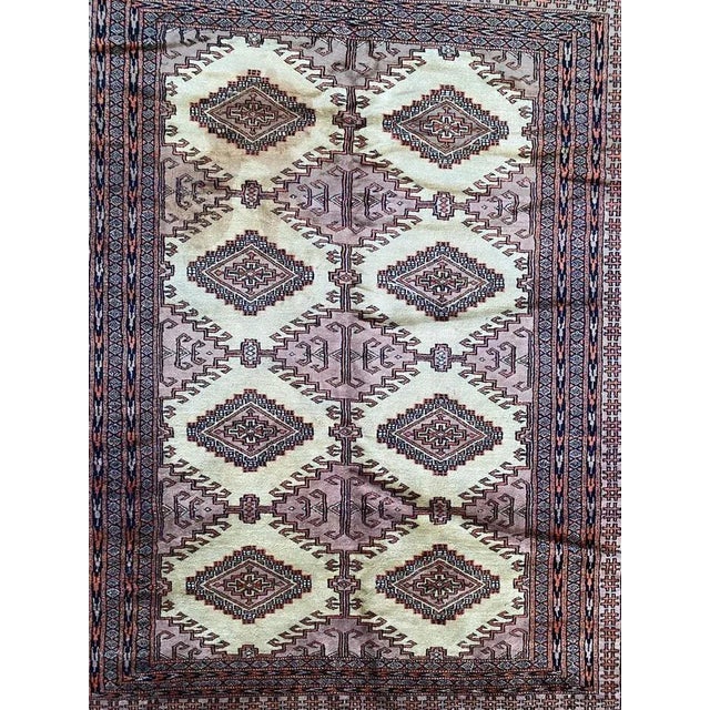 Beautiful midcentury Pakistani rug with a geometric Turkmen design and nice colors with pink, purple, yellow and black,...