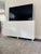 Odette Cabinet in White Lacquer A unique scalloped design conceals four doors which open to reveal ample storage. Both...