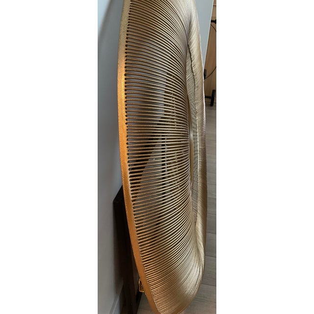 This is a large round mirror 42.13" diameter. Curved iron frame in gold finish, beveled mirror in the middle - mirror is...