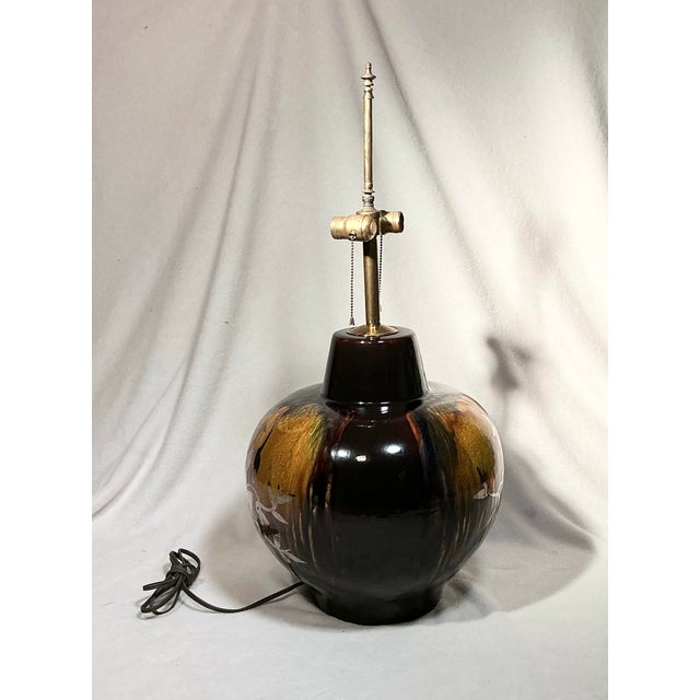 Oversized, vintage Mid-Century Modern art pottery table lamp. This large lamp features a silver overlay Gazelle Ram and...