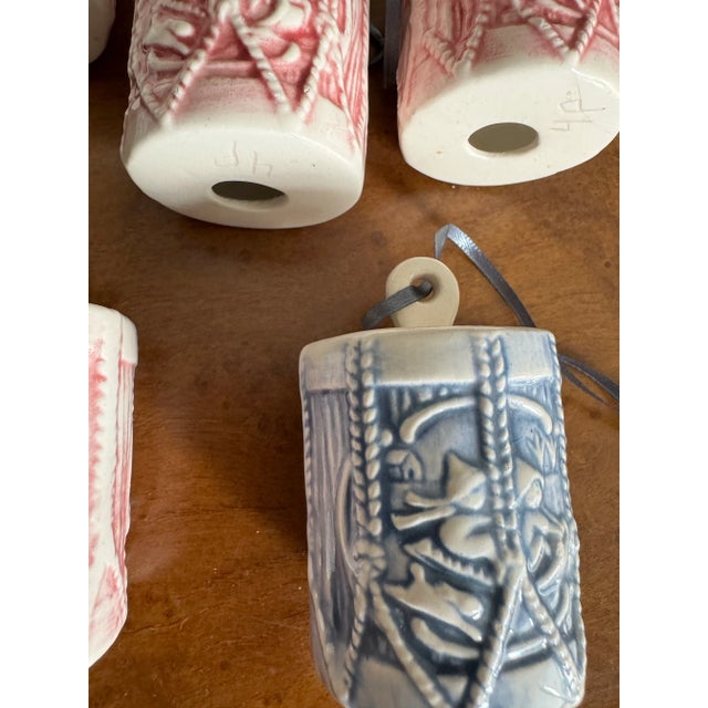 Set of nine blue and pink vintage hand crafted in the USA, porcelain drum shaped Christmas tree ornaments.