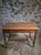 Elm table from France, dating from the 1920s. It has a rectangular top with a moulded edge, turned legs and connecting...