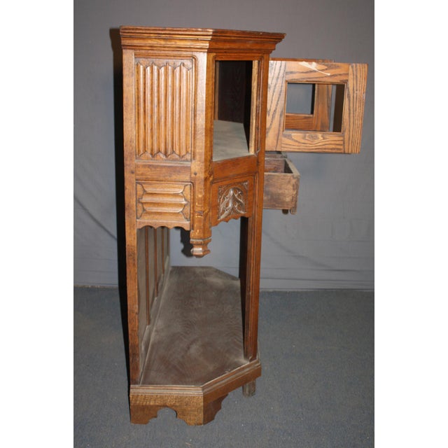 Rare carved oak wood server in dark tones. Carved Gothic tracery designs overhang the lower open part, with linenfold...