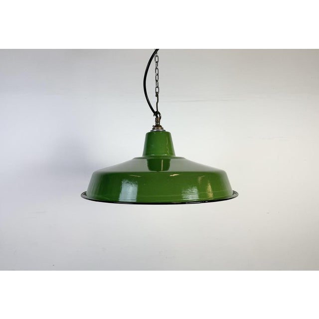 Industrial green enamel factory pendant light made in United Kingdom during the 1960s. White enamel inside the shade....