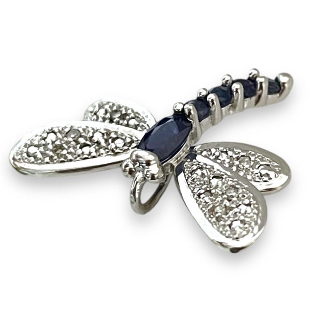 A delicate and elegant dragonfly pendant crafted in 14K white gold, featuring dazzling diamond-studded wings and a body...