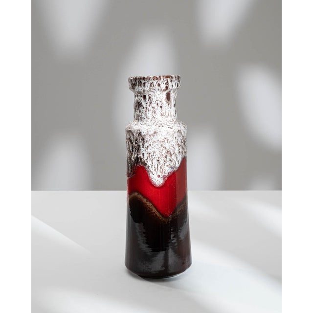 Indulge in the artistic allure of this 1960s German "W. Germany" ceramic vase, boasting a captivating fat lava design. The...