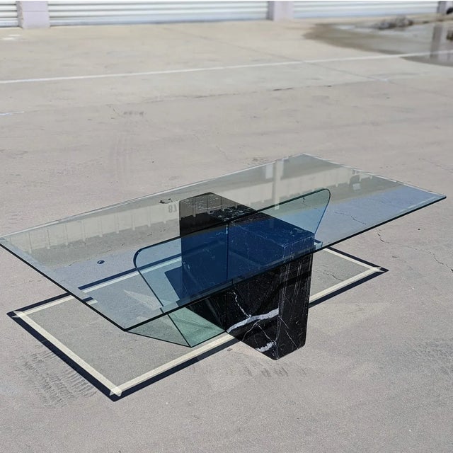 Bring timeless design into your home with this Postmodern coffee table in black marble and glass. Design Highlights: A...