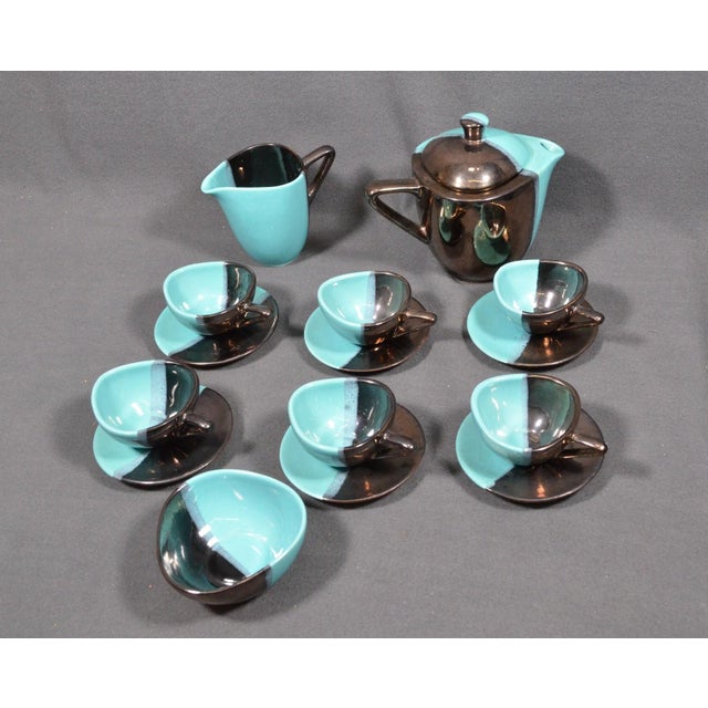 VALLAURIS Coffee set in black and turquoise blue faience, comprising a covered coffee pot, a milk jug, six cups with...