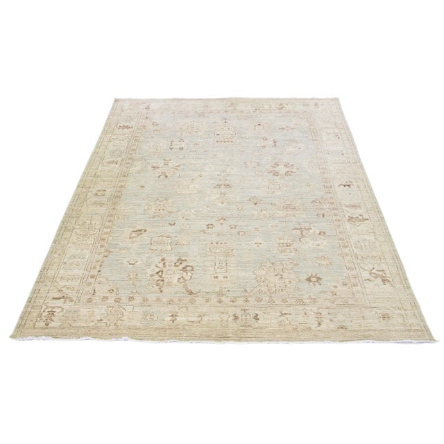Beautiful modern Oushak hand-knotted wool rug with a gray color field. This Piece has beige and brown accent colors in a...