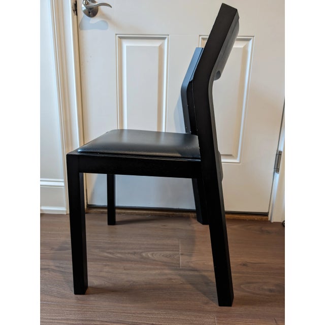 Profile Chair is designed by Matthew Hilton for Design Within Reach. This chair, made of solid wood frame and black...