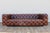 A stunning vintage Chesterfield-style sofa upholstered in rich distressed brown leather, manufactured by Restoration...