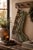 This vintage wool kilim stocking showcases an intricate floral medallion pattern in sage green, cream, and warm brown,...