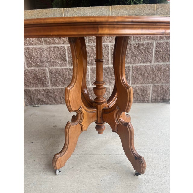 Antique Victorian Eastlake table carved porcelain wheels walnut manufactured in the 1800s dimensions are 23 1/2” x 32” x...