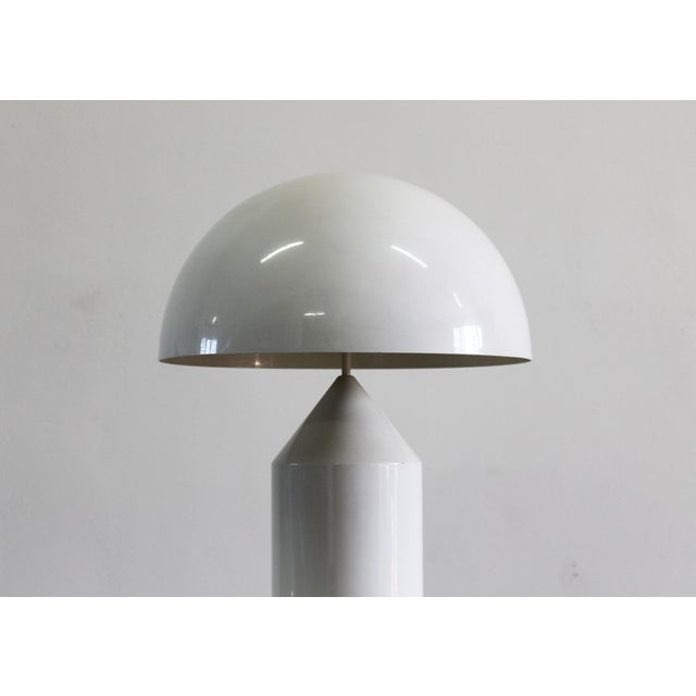 Atollo table lamp in white lacquered metal, designed by Vico Magistretti in 1977 and produced by Oluce. Source bulb: 2 x...