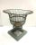 An elegant Victorian-style wire planter featuring an airy sculptural silhouette with a wide flared top and geometric...