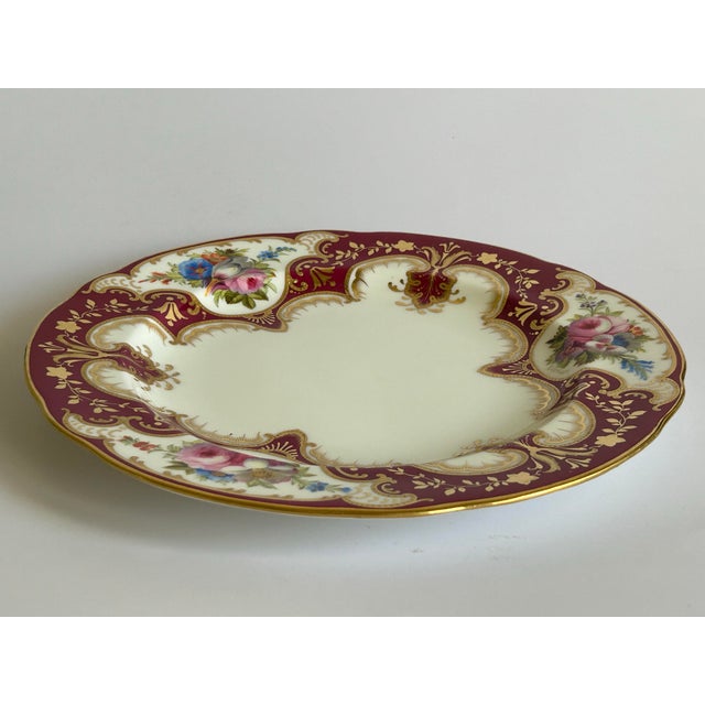 Exquisite Cauldon England porcelain cabinet plate features gold floral and leaves on burgundy ground alternating with...