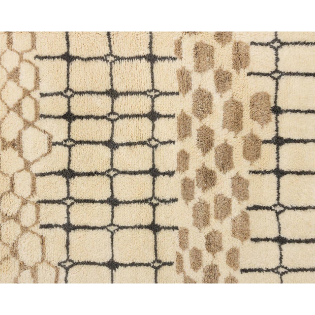 Wild meets structured: animal spots, honeycomb, and bold grids layered in rhythmic bands. An ivory base is divided into...