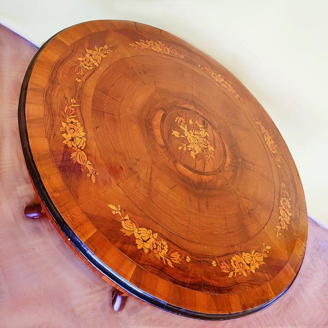 The base consists of four feet, on which stands a carved column surrounded by four finely sculpted dolphins with their...