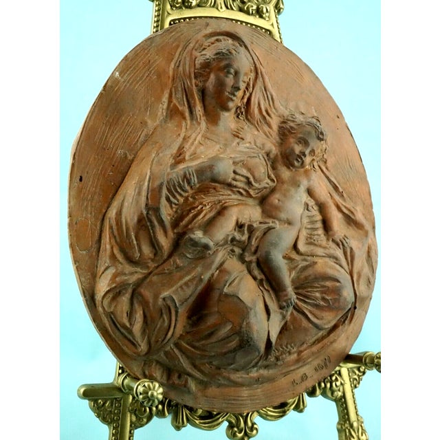 a wonderful plaque, an antique terracotta medallion, entirely hand-molded, a unique piece without a mold, signed with the...