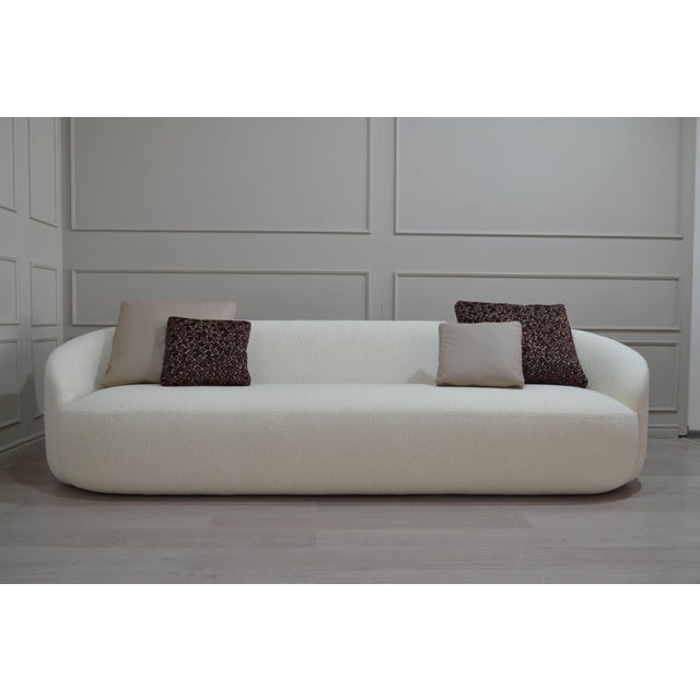 Curved Fully Upholstered Lounge Sofa: Sculptural low-profile sofa with continuous curved back, integrated rounded arms and...