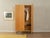 A classic wardrobe from the 1960s. The body is made of cherry veneer with two doors, one shelf, a clothes rail, and new...