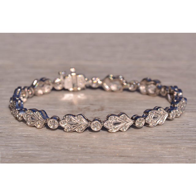 The 134th Street: White Gold Filigreed Foliage Bracelet with Diamonds. This exquisite bracelet showcases a stunning leafy...
