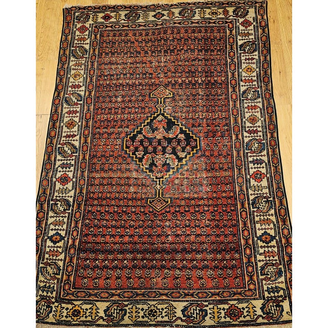 "This antique Persian Malayer rug, handwoven in the early 1900s, is a remarkable example of fine craftsmanship from the...