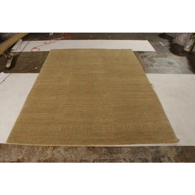 Made with hand-knotted wool, this contemporary rug hails from the select late-20th-Century works of Teddy Sumner joining...