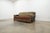 Vintage Western ranch-style sofa dating to the late 20th century, featuring a richly layered mix of distressed leather...