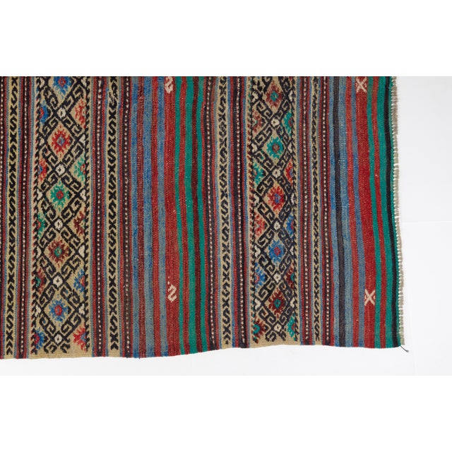 This is a vintage Turkish Oushak rug from the Mid 20th Century. The piece was hand-knotted.
