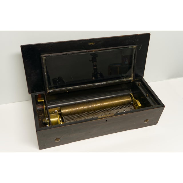 A beautifully crafted cylinder music box, a popular form of mechanical musical entertainment from the late 18th through...