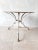 Antique Grassin à Arras garden table made of wrought iron with cast iron feet, with original weathered white-gray patina....