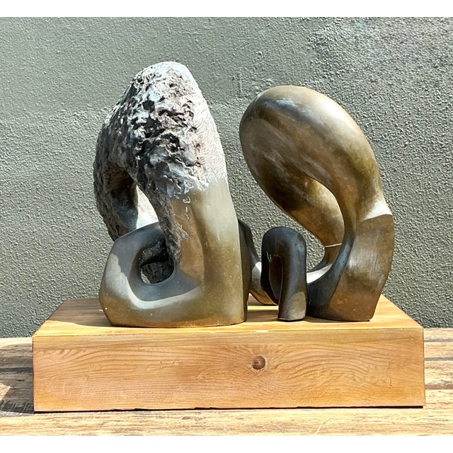 This monumental bronze sculpture is a tour de force of late 20th-century abstract art. Its biomorphic, intertwining forms...