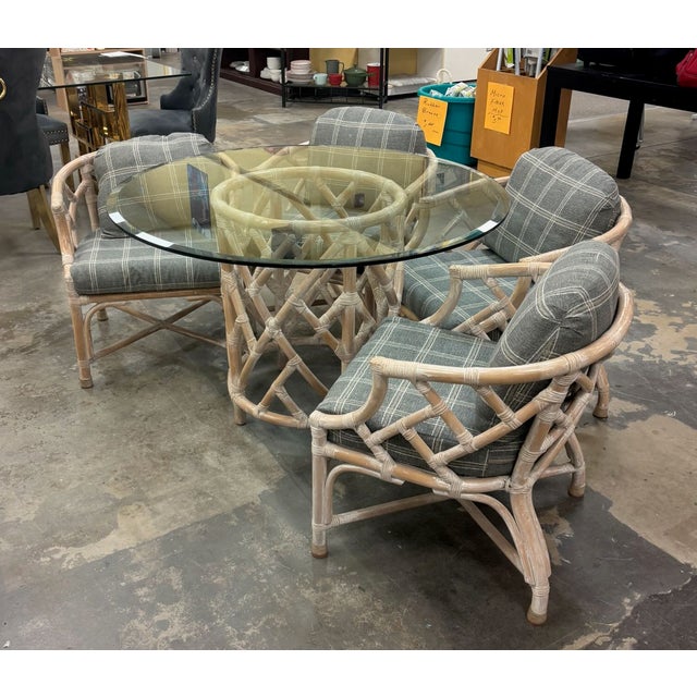 Rattan glass-top table with four armchairs by Henry Link. The Palm Regency style set has "cracked ice" or Chinese...