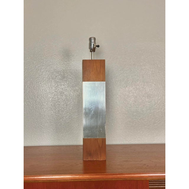 Modern Laurel Table Lamp finished with Dark Walnut and Chrome. The perfect mid century modern lamp. A central chrome plate...
