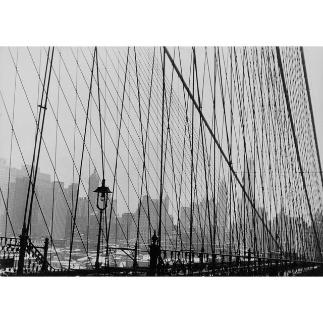 Manhattan Bridge Manhattan skyline seen through the meshes in the railing of Manhattan Bridge, New York City, US, circa...