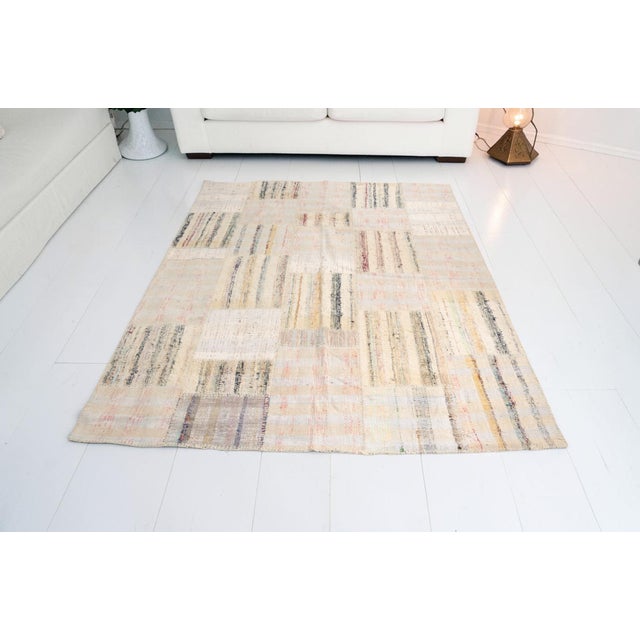 This is a vintage Turkish Oushak rug from the Mid 20th Century. The piece was hand-knotted.