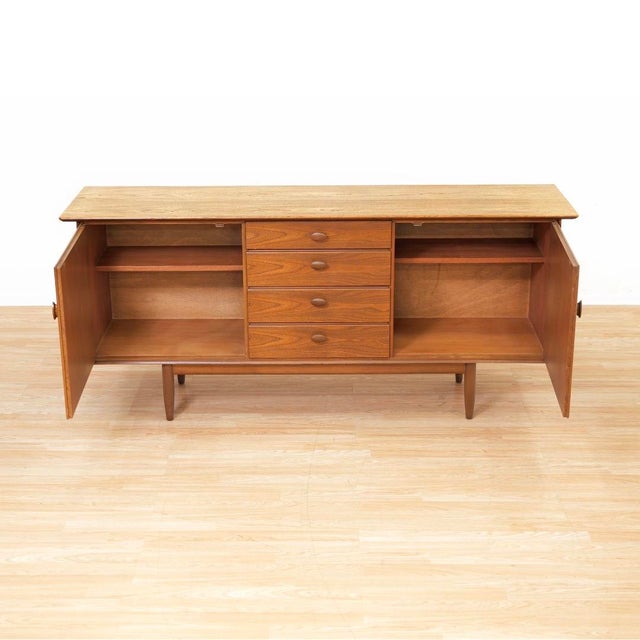 A superbly crafted mid-century credenza by Scandart Furniture. Produced during the 1960s, the cabinet has a minimalist...