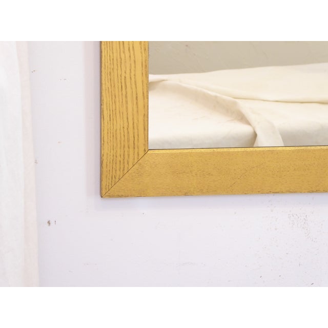 This turn of the century golden oak mirror measures 38.5"H x 34"W.