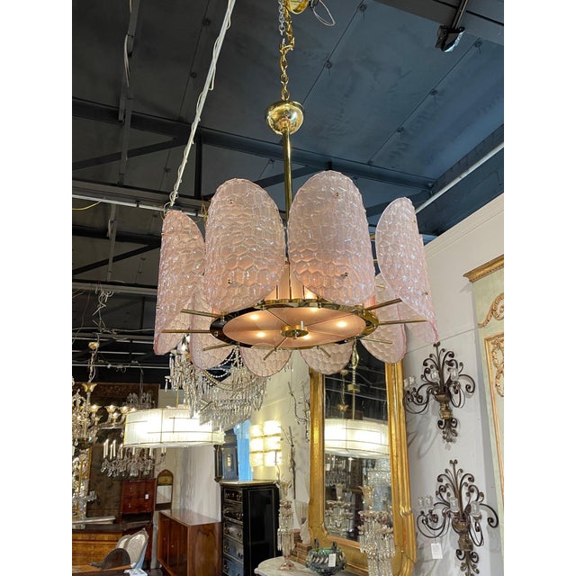 Exquisite Italian pink Murano glass and brass disc chandelier, with UL Listing. The textured glass on the discs is a...