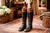 A striking and character-filled pair of antique English horse riding boots, dating to around 1900, these tall black...